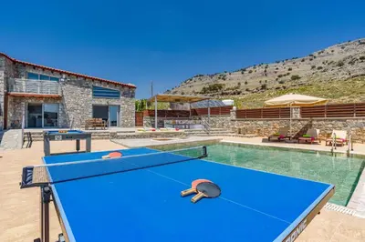 a pool table with ping pong balls on it at Villa Dione Seastone by Villa Plus in Kiotari