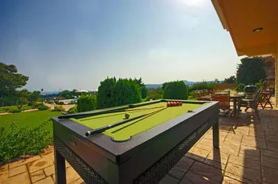 a pool table sitting on top of a patio at Villa Helios Rodos by Villa Plus in Asgourou
