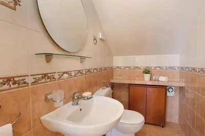a bathroom with a sink and a toilet and a mirror at Villa Helios Rodos by Villa Plus in Asgourou