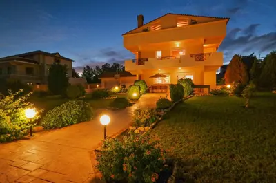 a large house with lights in the yard at Villa Helios Rodos by Villa Plus in Asgourou