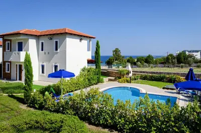 a villa with a swimming pool and a house at Villa Matina by Villa Plus in Líndos