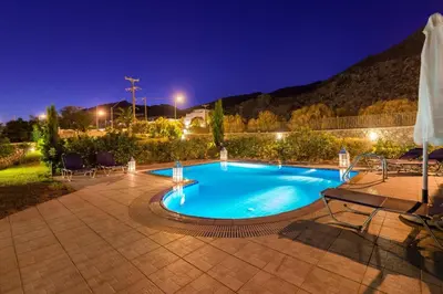 a swimming pool in the middle of a patio at night at Villa Matina by Villa Plus in Líndos