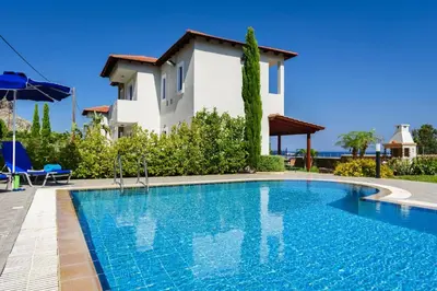 a villa with a swimming pool in front of a house at Villa Matina by Villa Plus in Líndos