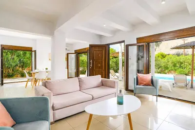 a living room with a couch and a table at Villa Maya by Villa Plus in Pefki Rhodes