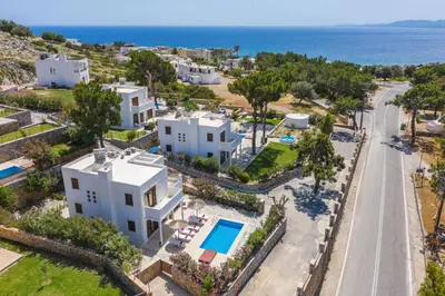 an aerial view of a villa with a road and the ocean at Villa Maya by Villa Plus in Pefki Rhodes