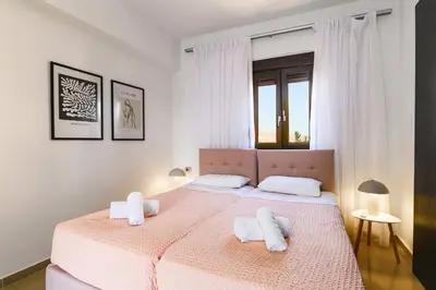 a bedroom with a bed with two towels on it at Villa Maya by Villa Plus in Pefki Rhodes