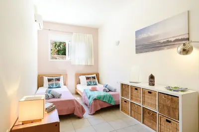 a bedroom with two beds and a desk in it at Villa Selini by Villa Plus in Pefki Rhodes