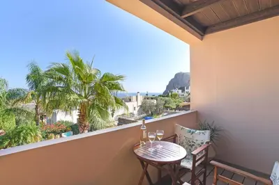 a balcony with a table and two chairs and a view at Villa Selini by Villa Plus in Pefki Rhodes