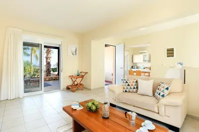 a living room with a couch and a table at Villa Selini by Villa Plus in Pefki Rhodes