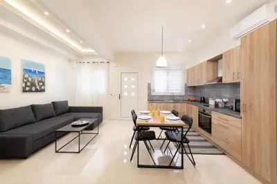 a living room with a couch and a table at Asterashouse in Rhodes Town