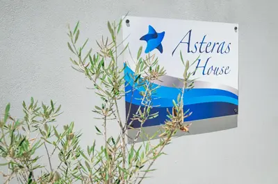 a sign on a wall with a house at Asterashouse in Rhodes Town