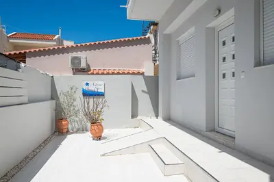 a courtyard of a house with white walls and a door at Asterashouse in Rhodes Town