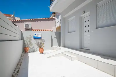a white house with a door and potted plants at Asterashouse in Rhodes Town