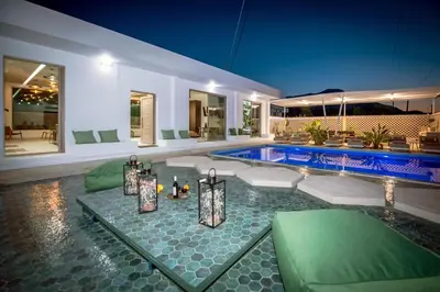 a home with a swimming pool and a house at Villa Gaia Green-Adults only in Kolimbia