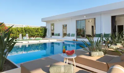 a villa with a swimming pool and a house at Villa Gaia Green-Adults only in Kolimbia