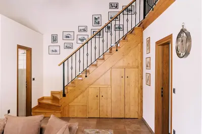 a staircase in a home with a wooden door at Stavlos Luxury Stone House in Ialyssos