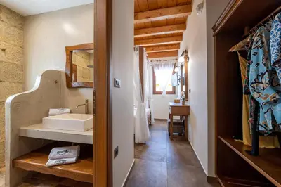 a bathroom with a sink and a mirror at Stavlos Luxury Stone House in Ialyssos