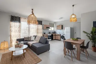 a living room with a couch and a table at Port Living Apartments in Rhodes Town