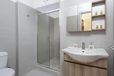 a bathroom with a sink and a shower at Port Living Apartments in Rhodes Town