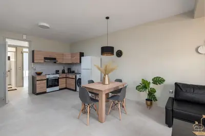 a kitchen and living room with a table and chairs at Port Living Apartments in Rhodes Town