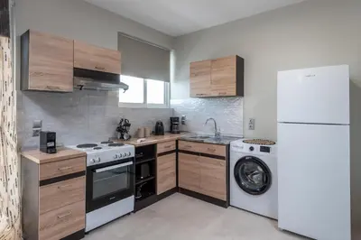 a kitchen with a white refrigerator and a washing machine at Port Living Apartments in Rhodes Town
