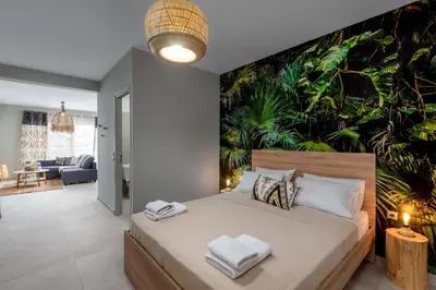 a bedroom with a large bed with towels on it at Port Living Apartments in Rhodes Town