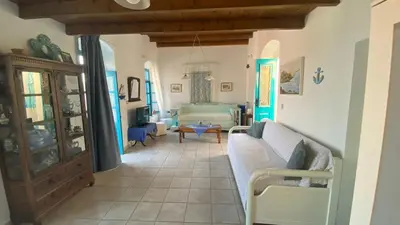a living room with a couch and a bedroom at Kleopatra Sweet Home in Symi