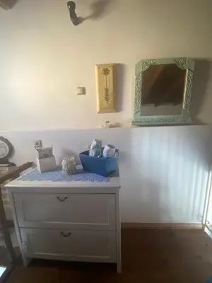 a white dresser with a mirror on a wall at Kleopatra Sweet Home in Symi