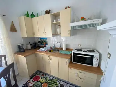 a small kitchen with a sink and a microwave at Kleopatra Sweet Home in Symi