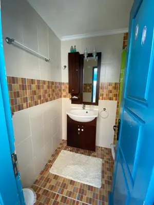 a bathroom with a sink and a toilet at Kleopatra Sweet Home in Symi