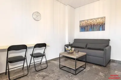 a living room with a couch and two chairs at Rhodes Heart Apartments close to the old town in Rhodes Town