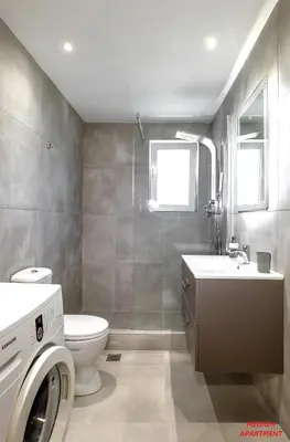 a bathroom with a toilet and a sink and a washing machine at Rhodes Heart Apartments close to the old town in Rhodes Town