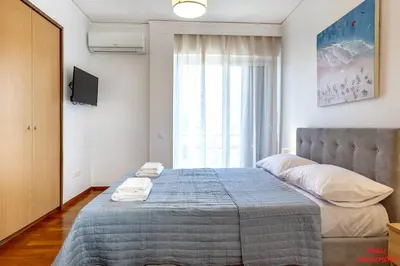 a bedroom with a large bed with two towels on it at Rhodes Heart Apartments close to the old town in Rhodes Town
