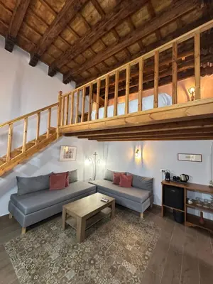 a living room with two couches and a loft at Midgard Suites (Medieval Town) in Rhodes Town