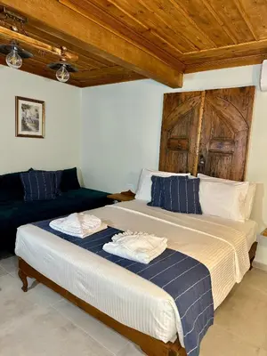 a bedroom with a large bed and a couch at Midgard Suites (Medieval Town) in Rhodes Town