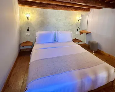 a bedroom with a large white bed with two pillows at Midgard Suites (Medieval Town) in Rhodes Town
