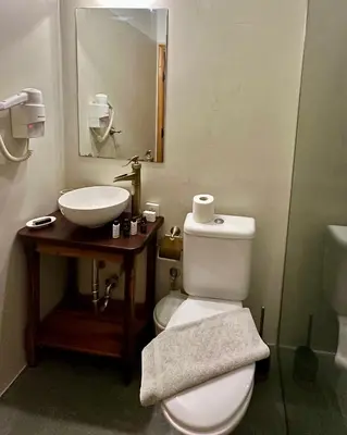 a bathroom with a white toilet and a sink at Midgard Suites (Medieval Town) in Rhodes Town