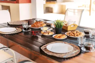 a wooden table with plates of food on it at Villa Maribia with Private pool in Gennadi