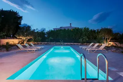 a swimming pool with lounge chairs and a house at Villa Maribia with Private pool in Gennadi
