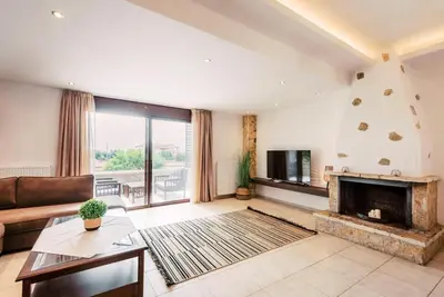 a living room with a couch and a fireplace at Villa Maribia with Private pool in Gennadi