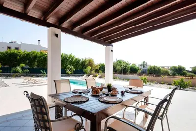 a wooden table and chairs on a patio at Villa Maribia with Private pool in Gennadi