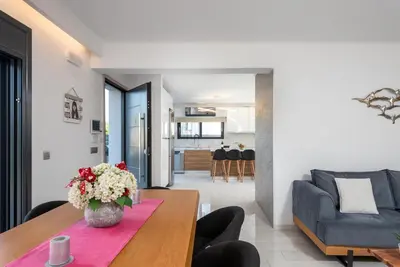 a living room with a table and a couch at Rhodes Villa Billys in Asgourou