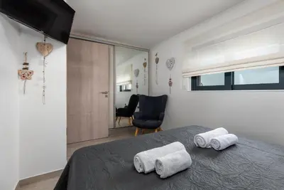 a bedroom with a bed with two towels on it at Rhodes Villa Billys in Asgourou