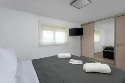 a bedroom with two towels on a bed with a mirror at Rhodes Villa Billys in Asgourou
