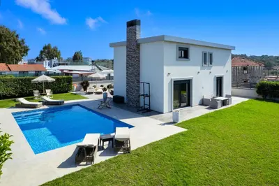 a backyard with a swimming pool and a house at Rhodes Villa Billys in Asgourou