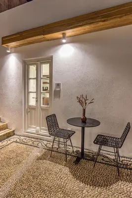 a table and two chairs in a room at Peni sol Superior Studios Lindos in Líndos
