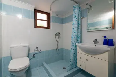 a bathroom with a toilet and a sink at Villa Leleka in Halki
