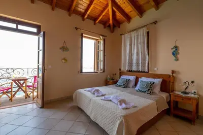 a bedroom with a bed with towels on it at Villa Leleka in Halki