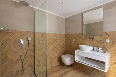 a bathroom with a sink and a shower at Cedrus Blue in Symi