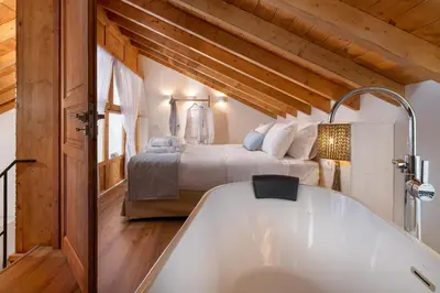 a bath tub in a room with a bed at Cedrus Blue in Symi